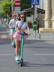 People riding electric scooters